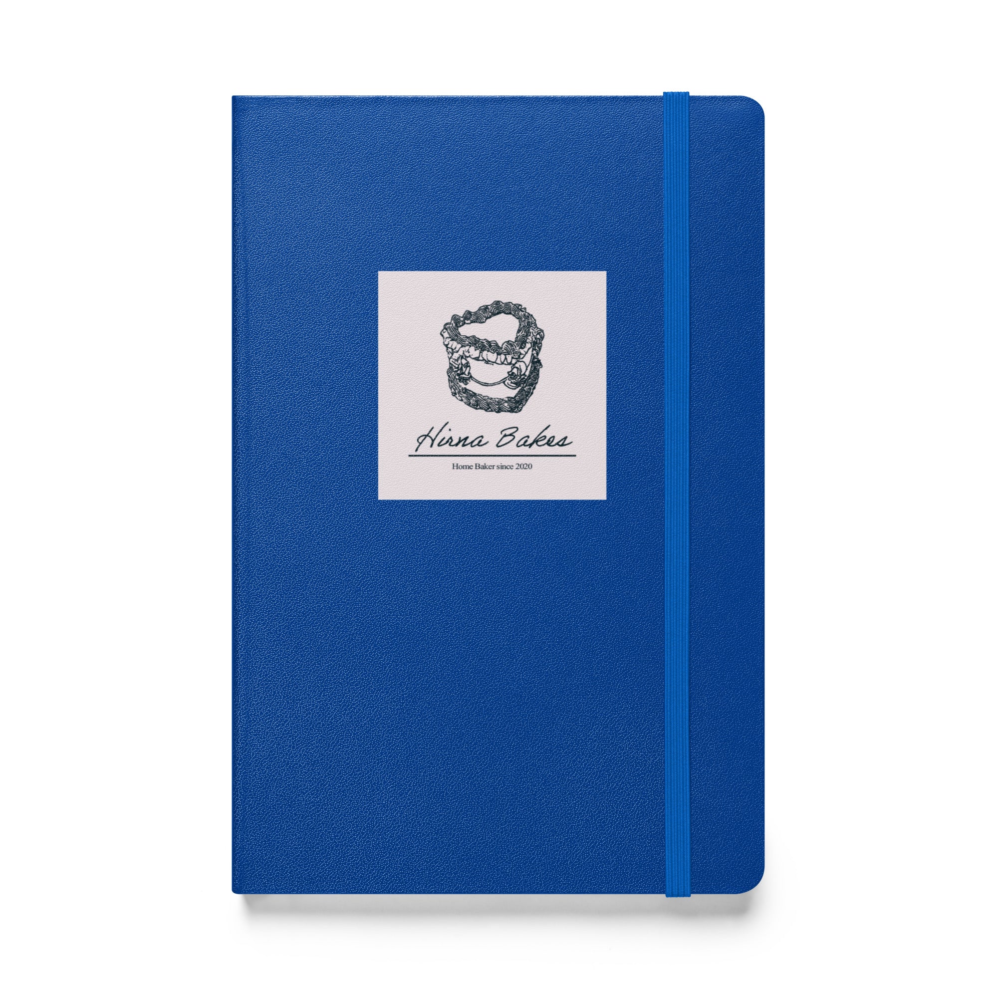Blue hardcover notebook with Hirna Bakes logo sticker on the front