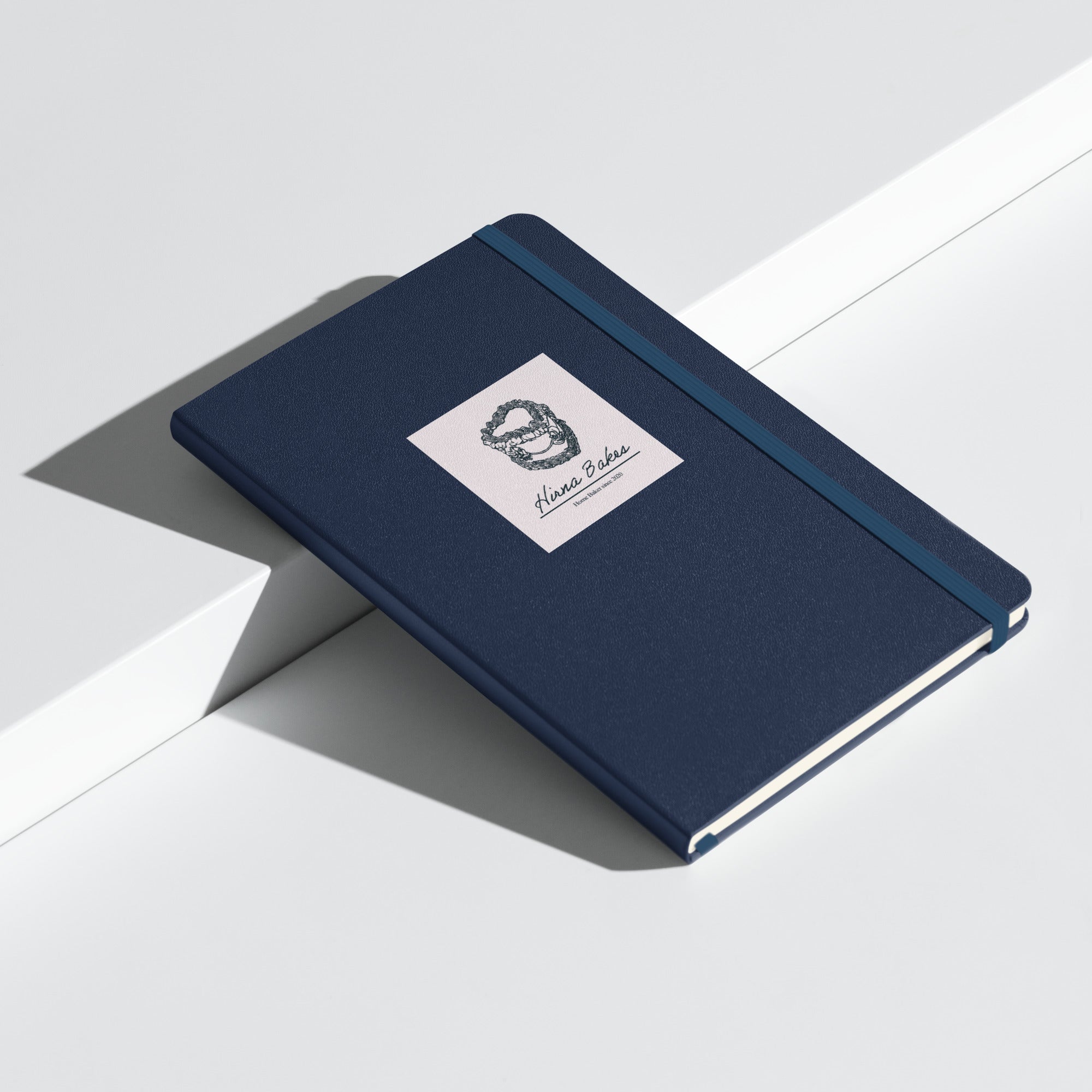 Navy hardcover bound notebook with Hirna Bakes logo, handmade gift from Hirna Bakes Buckinghamshire