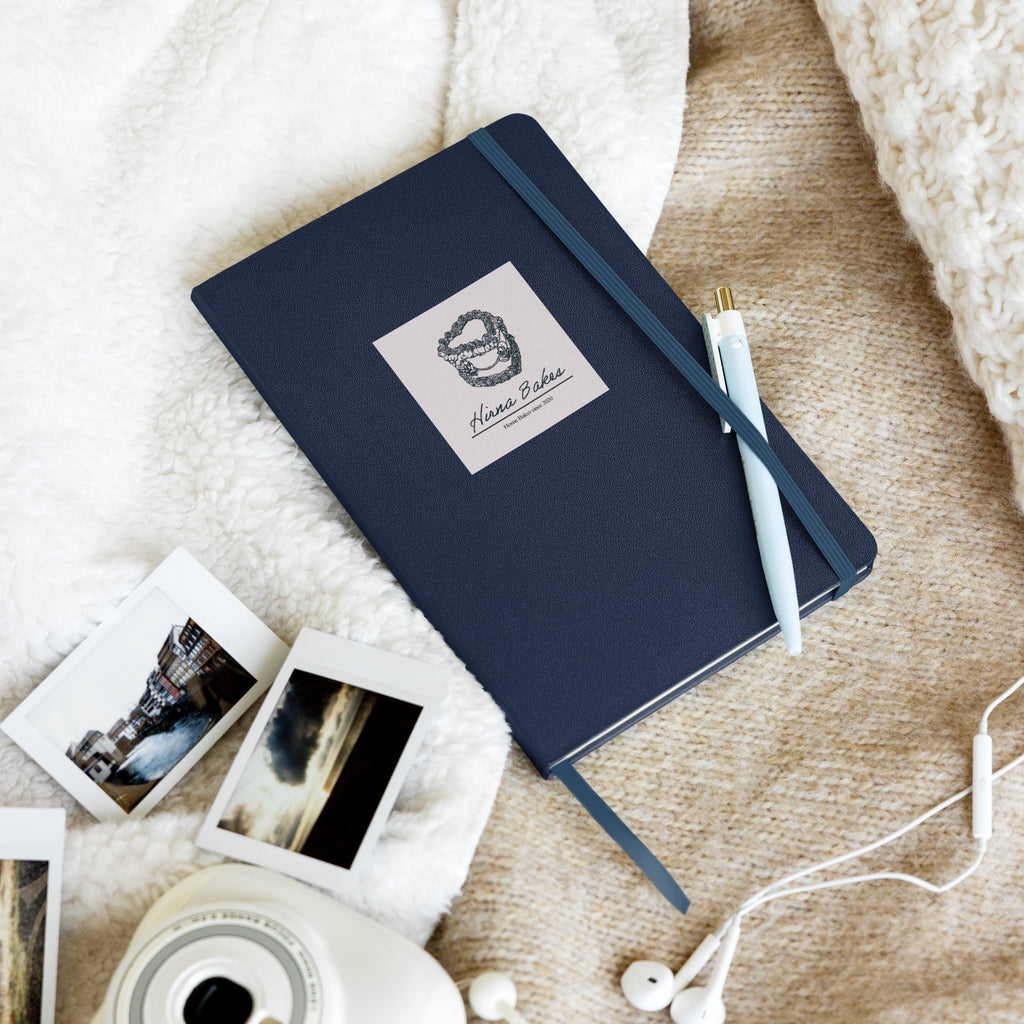Hirna Bakes navy hardcover notebook gift, cosy autumn flatlay with pen and Polaroid photos, handmade in Buckinghamshire